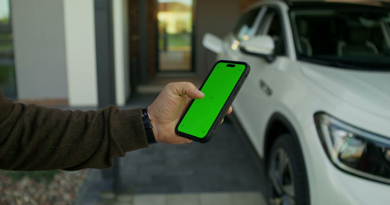 Hand Swiping Green Screen Smartphone by Car