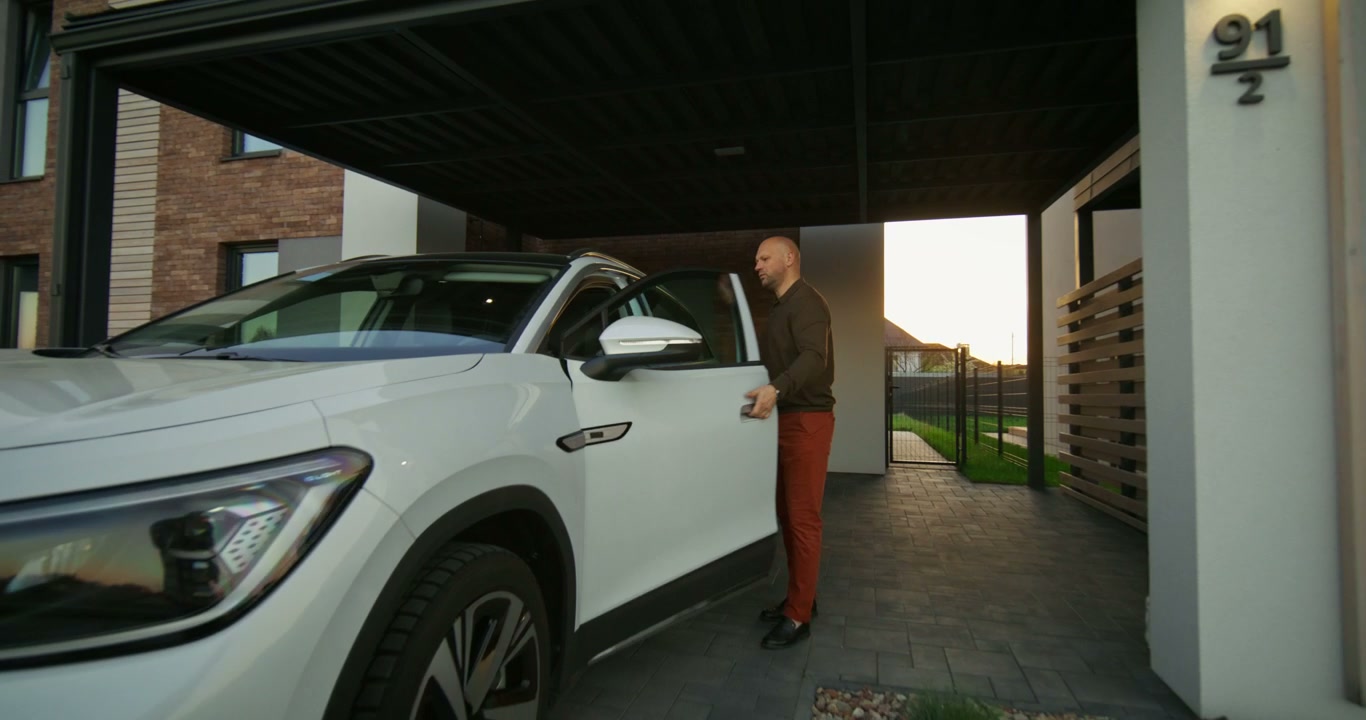 Man Drives Electric SUV from Carport