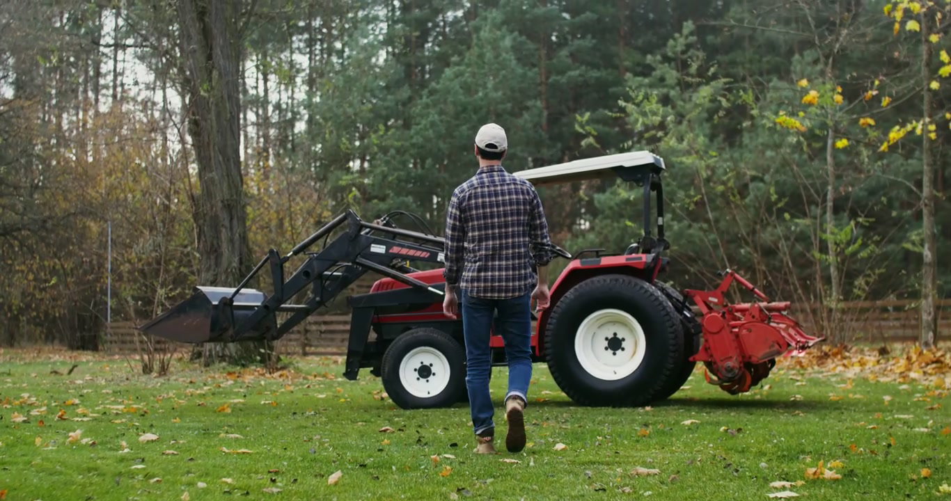 Man Getting Into a Tractor