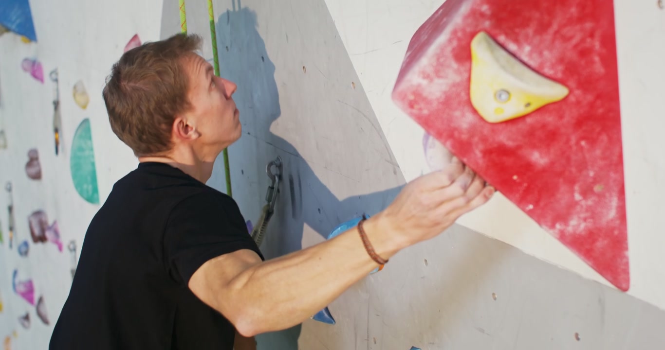 Man Climbing Indoor Rock Wall
