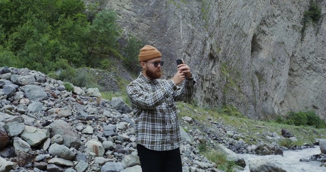 Man Recording Video with Phone at Iguazu Falls • Stock Video on Uppbeat