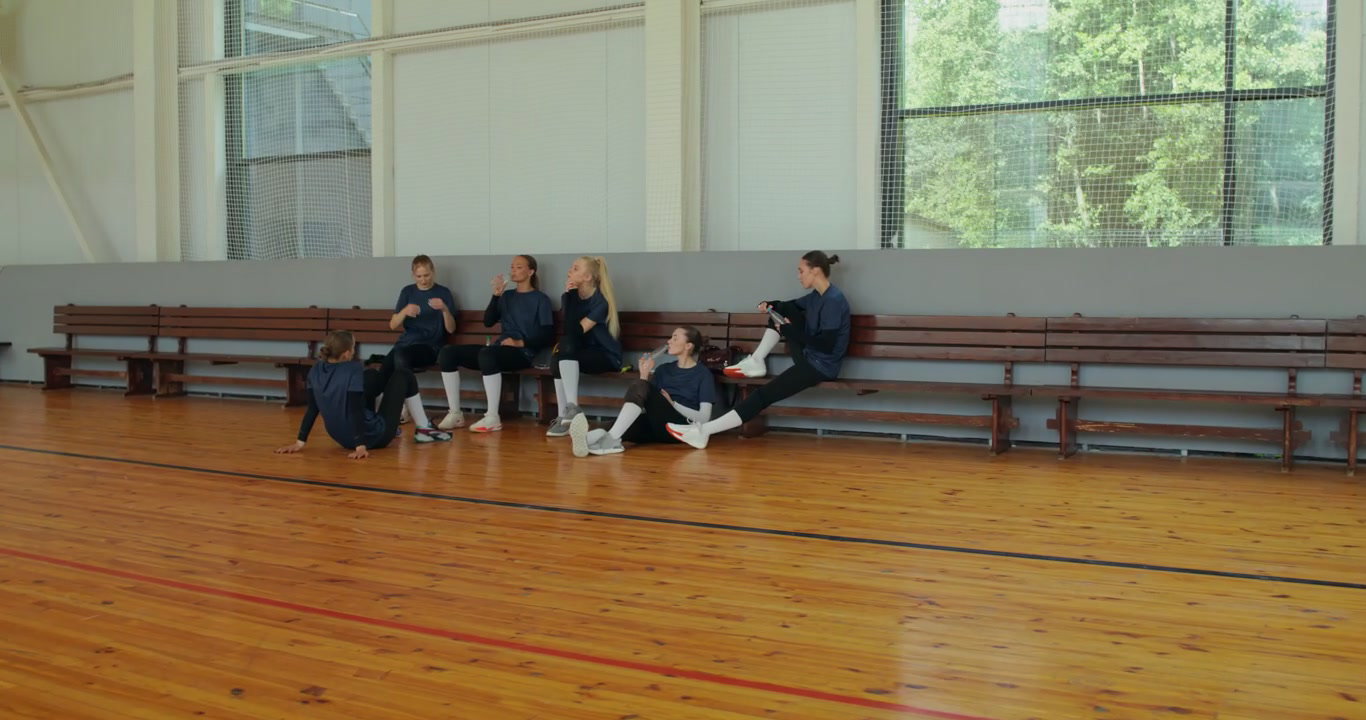 Volleyball Team Resting in Gymnasium